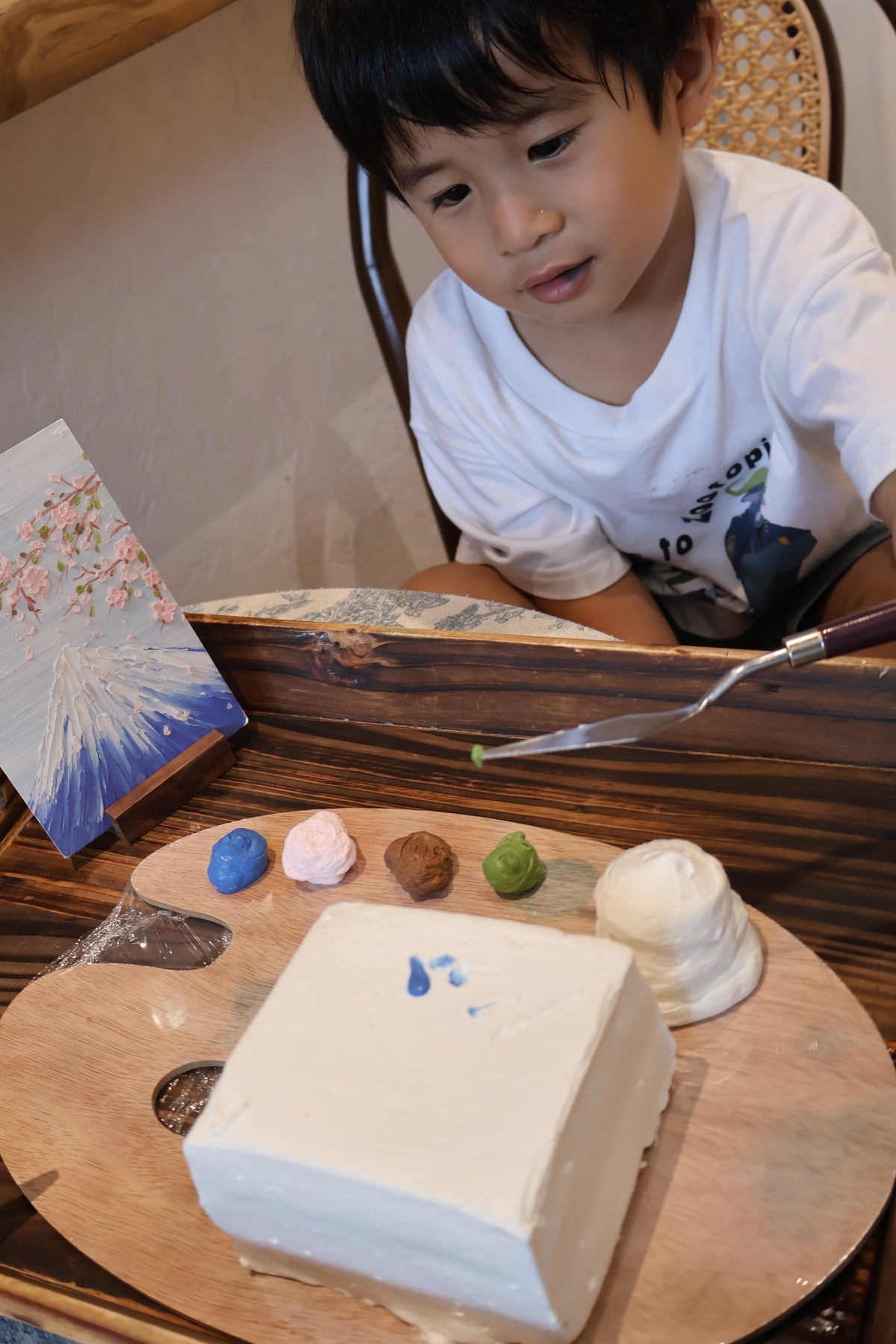 child painting cake